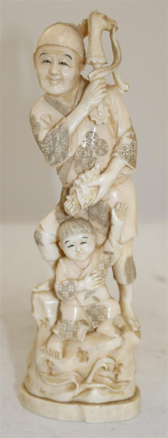 A Japanese walrus ivory okimono of a man and a boy, early 20th century, 23.5cm